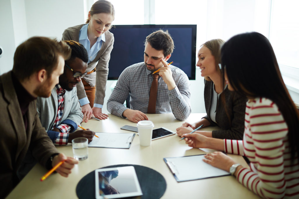 Business people consulting around table